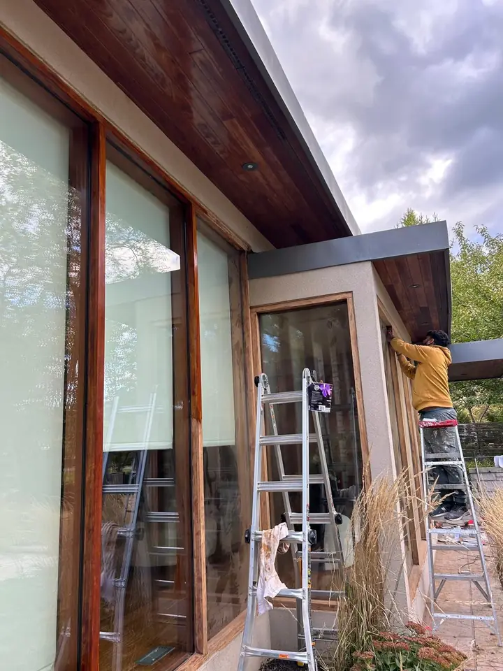 Ladder work along the house exterior