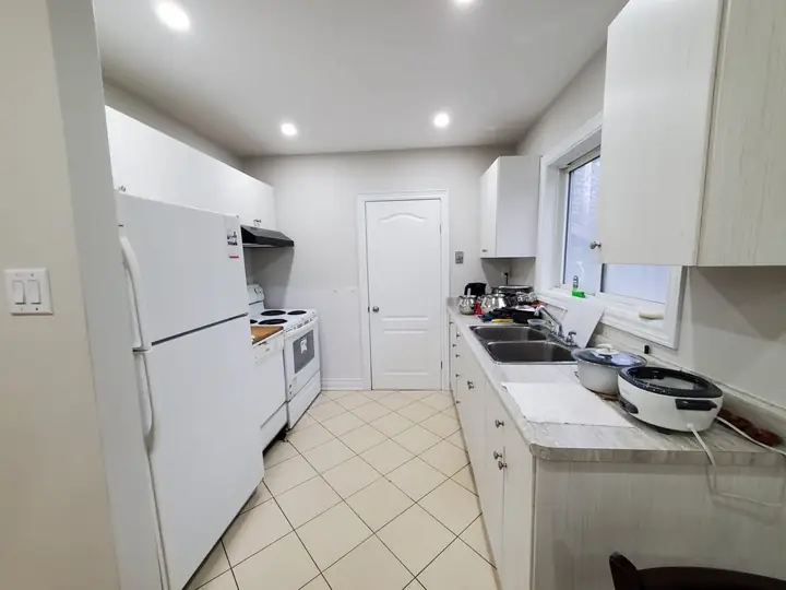 Kitchen with window and white cabinets
