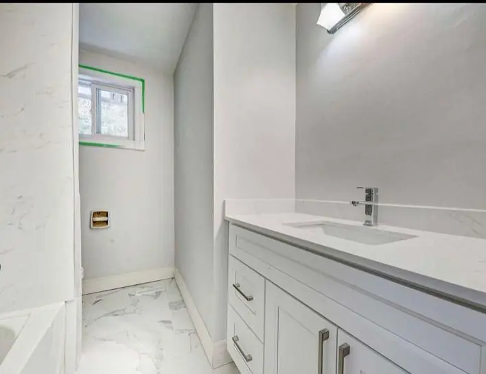 Bathroom with tub and mirror